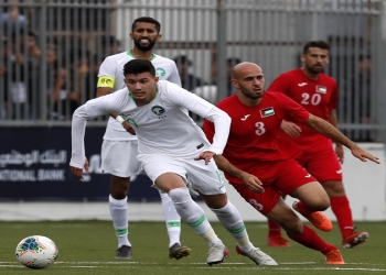 Saudi player Abdullah Abdulrahman Alhamddan views for the ball with Palestinian player Mohammed Rashid during a World Cup 2022 Asian qualifying match between Palestine and Saudi Arabia in the town of al-Ram in the Israeli occupied West Bank on October 15, 2019. - The game would mark a change in policy for Saudi Arabia, which has previously played matches against Palestine in third countries. Arab clubs and national teams have historically refused to play in the West Bank, where the Palestinian national team plays, as it required them to apply for Israeli entry permits. (Photo by Ahmad GHARABLI / AFP)