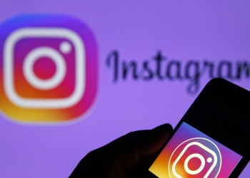 PARIS, FRANCE - DECEMBER 10: In this photo illustration, the Instagram logo is displayed on the screen of an iPhone in front of a TV screen displaying the Instagram logo on December 10, 2019 in Paris, France. The Instagram social photo and video sharing website wants to prevent young teenagers from accessing its platform. According to his statement, released this December 4, the legal age to access the platform will be 13 years to stop viewing some violent content or cyberstalking that young people may be victims. (Photo by Chesnot/Getty Images)