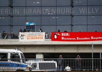 Climate activists attend a protest against the official opening of the new Berlin-Brandenburg Airport (BER) "Willy Brandt", in Schoenefeld near Berlin, Germany October 31, 2020. REUTERS/Fabrizio Bensch
