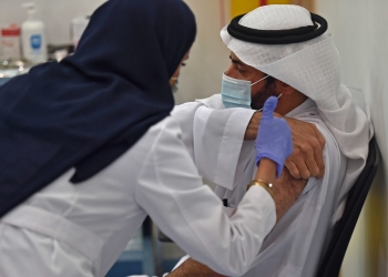 This picture taken on December 17, 2020 shows Saudi Arabia's Health Minister Tawfiq al-Rabiah waiting to receive the Pfizer-BioNTech COVID-19 coronavirus vaccine (Tozinameran) in the capital Riyadh, as part of a vaccination campaign by the Saudi health ministry. (Photo by FAYEZ NURELDINE / AFP)