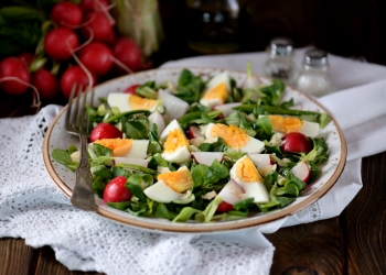Spring green salad from organic radish, wild garlic with boiled eggs, olive oil and parmesan.