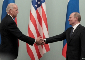 FILE PHOTO: Russian Prime Minister Vladimir Putin (R) shakes hands with U.S. Vice President Joe Biden during their meeting in Moscow March 10, 2011. REUTERS/Alexander Natruskin (RUSSIA - Tags: POLITICS)/File Photo