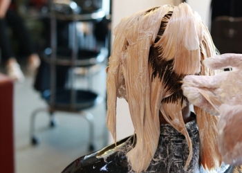light color wet hair are whole head applying in salon